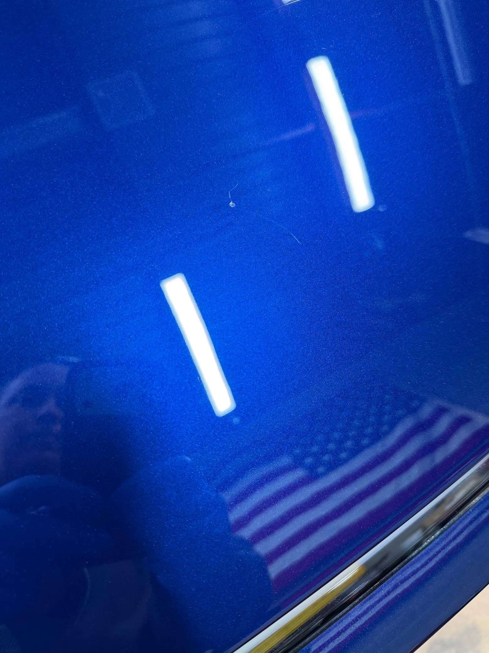 Deep gloss on a blue Tesla panel after a Revivify coating