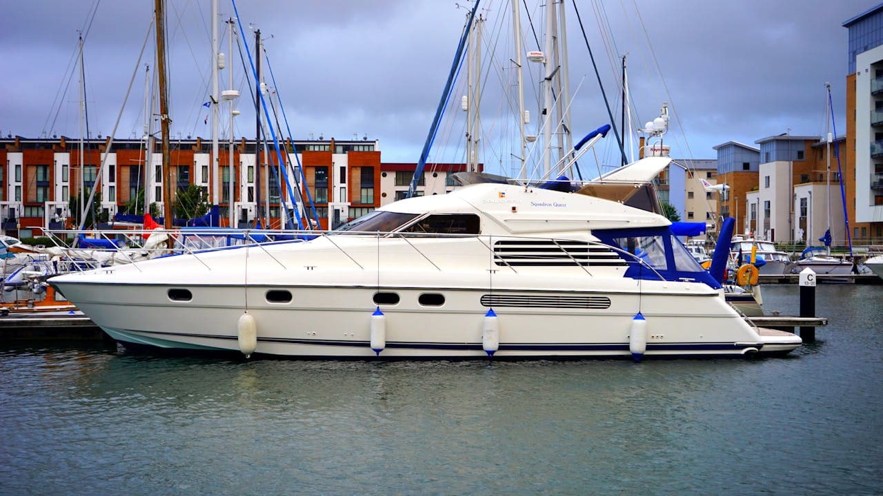 White motor yacht moored in a marina