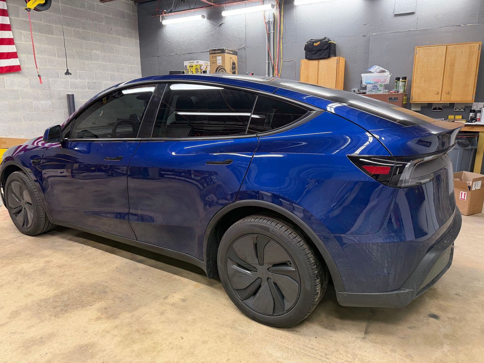 Blue Tesla receiving window tint at the Dynamite Details studio