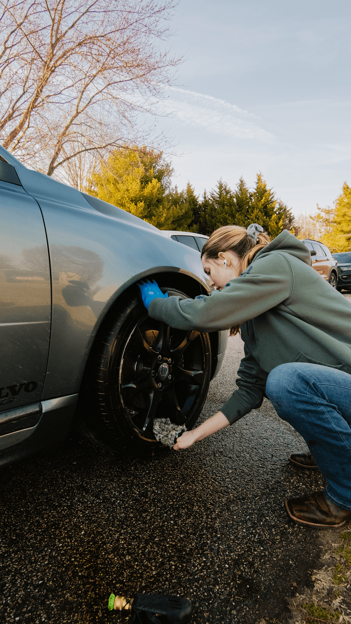 Detailer hand-cleaning a wheel during a Dynamite Details service